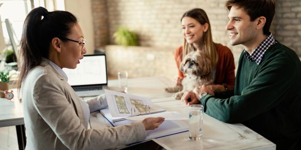 Couple consulting an expert with a dog.