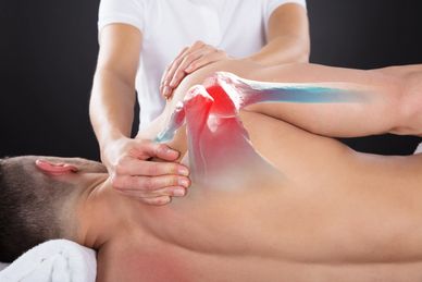 Therapist massaging a shoulder with highlighted joint pain area.