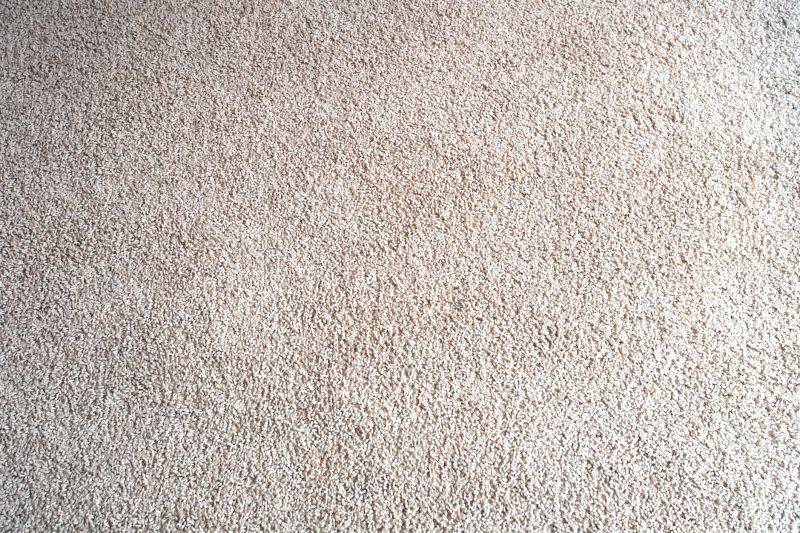 Bright beige wool fabric carpet or rug background texture close-up new and clean
