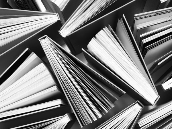 Top view of open books arranged in a pattern, showcasing their pages.