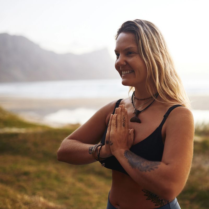 Cropped shot of an attractive young woman standing alone and meditating during a relaxing day outdoors