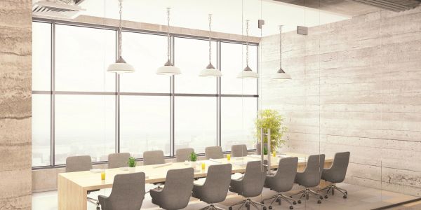 Modern conference room with large windows and comfortable chairs.