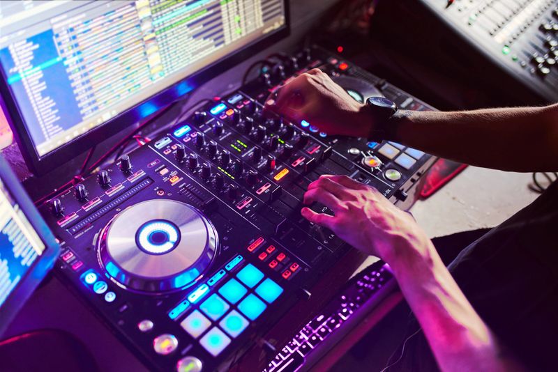 Mixing, and Scratching in a Night Club, Hands of dj soft focus, close up.