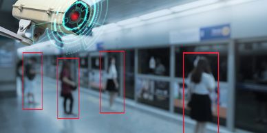 Security camera monitoring people in a subway station with highlighted individuals.