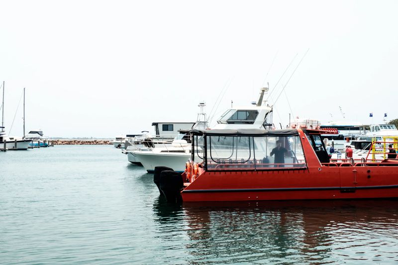 Group of various luxury yachts and fishing boats parked at pier near Nelson Bay of New South Wales, Australia
