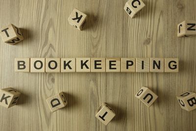 Wooden letter blocks spelling out the word "bookkeeping"