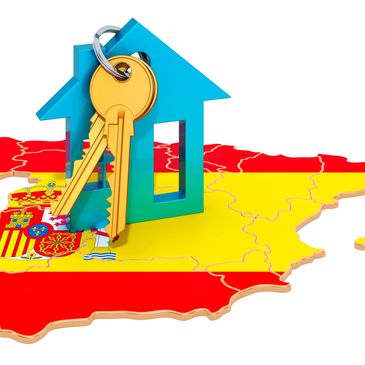 House keys on a blue house shape over Spain map with flag colors.