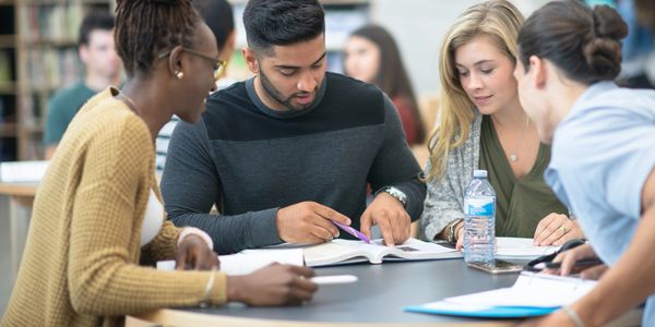 A diverse group of students studying together at a table.