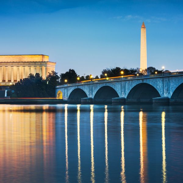 Washington D.C. landmarks at dusk with reflections on water.