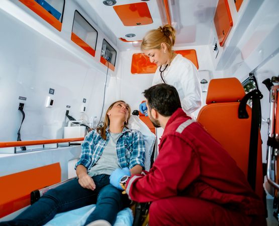Doctor consulting an elderly woman in a wheelchair with a tablet.