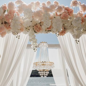 A canopy with a chandelier at Secrets Maroma Beach set up for a luxury wedding ceremony.
