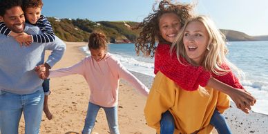 family frolicking on a beach