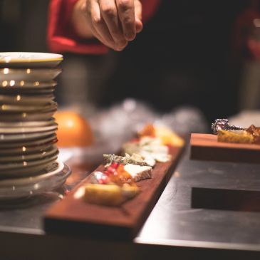 Chef adding finishing touches to gourmet dishes.