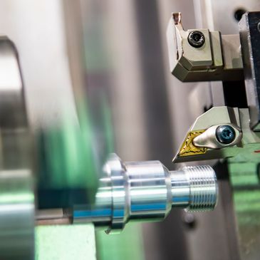 Close-up of a CNC lathe machine shaping a metallic workpiece.