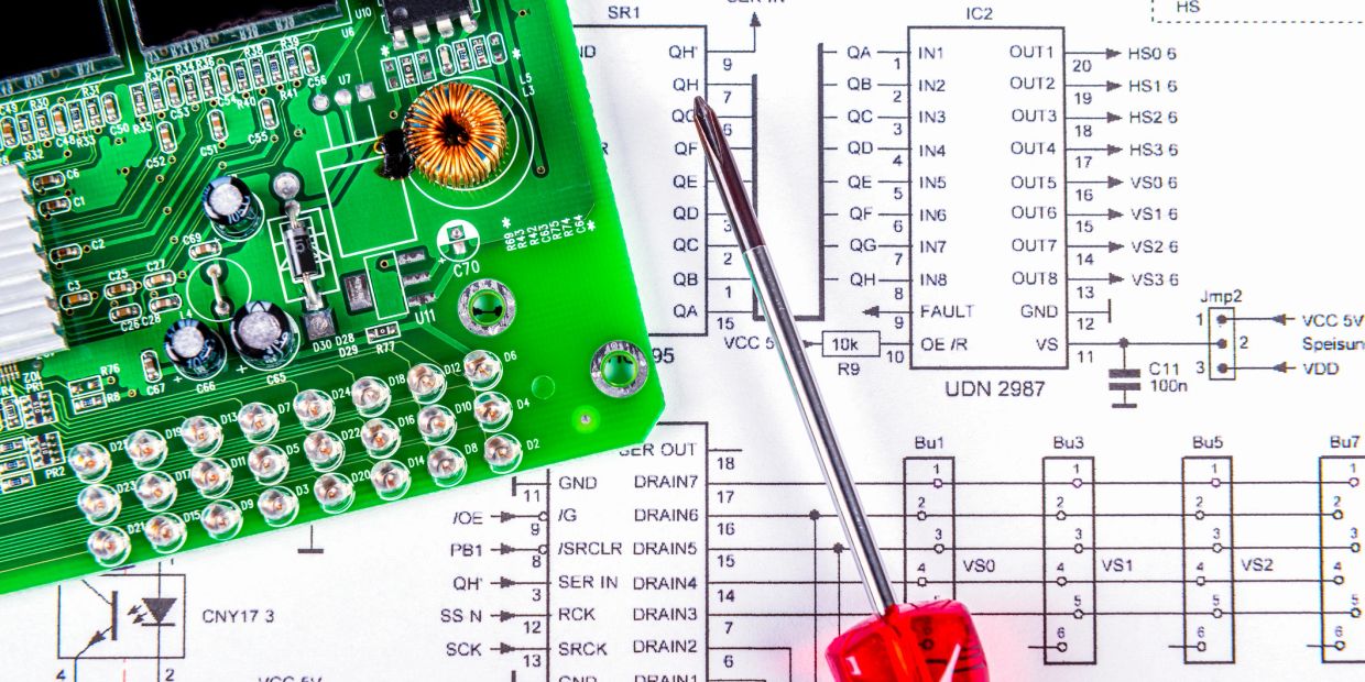 Green circuit board and screwdriver on a technical schematic.