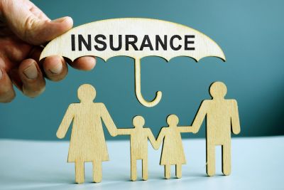 Insurance protects a family under an umbrella.
