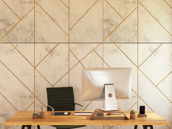 Modern minimalist office desk setup with a computer and chair.