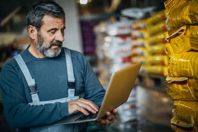 A man browsing on a pc in a wearhouse .