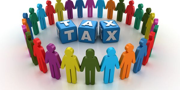 Colorful figures holding hands around blocks spelling TAX.