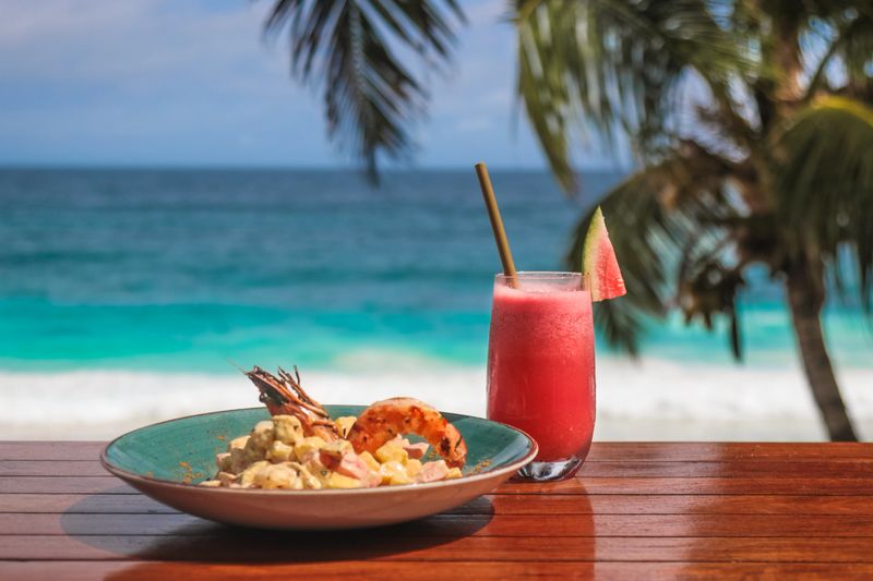 Seychelles Seafood Lunch salad with prawn and coconut by the beach