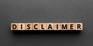 Wooden blocks spelling 'DISCLAIMER' on black background.
