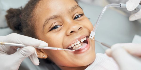 Happy child receiving dental care.