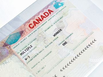 Close-up of a Canadian work permit visa in a passport.