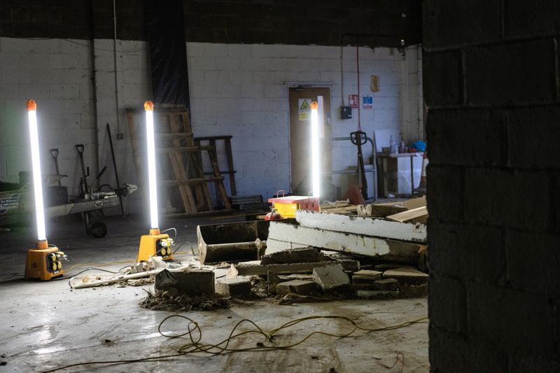 Work lights lighting a demolition area on work site for safety