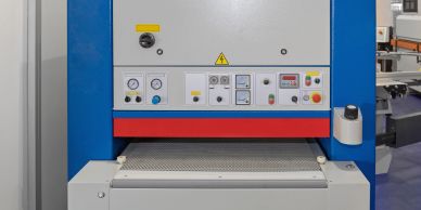 Industrial machine with control panel and conveyor belt.