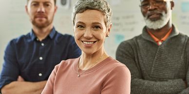 . A woman and two men are looking ahead. 