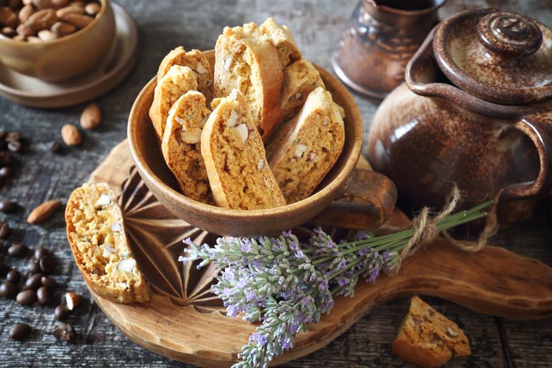 Italian cookies: almond and lavender cantuccini on wooden background. Focus selective