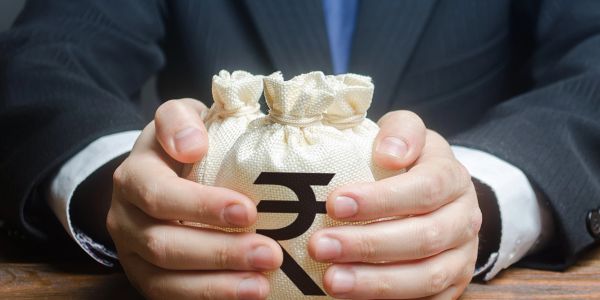 Hands holding a money bag with Indian Rupee symbol.