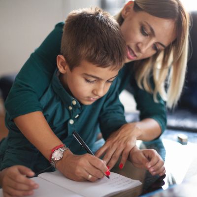 Mother helping son with homework.