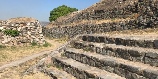 Ancient stone stairs and walls in an outdoor setting.