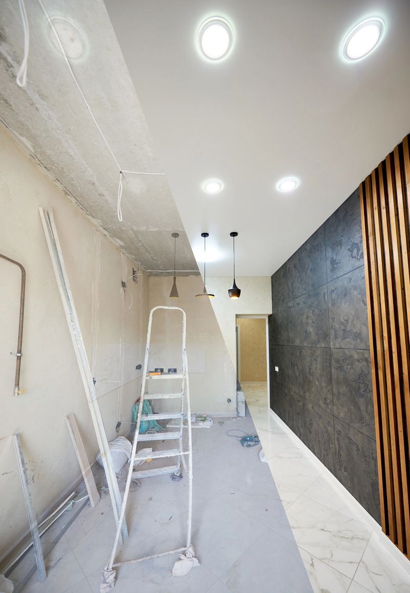 Renovation concept, new kitchen before renovation works and after, shiny tiles on the floor, modern chandeliers hanging from ceiling vs messy room with ladder in the middle