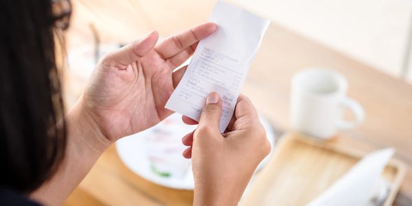 Woman holding a receipt.