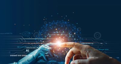 Human hand and robot hand nearly touching with AI digital interface.