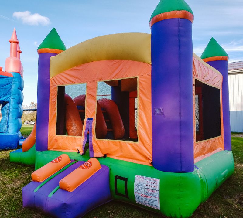 Colorful square children's bounce house with oranges, blues, greens and yellows