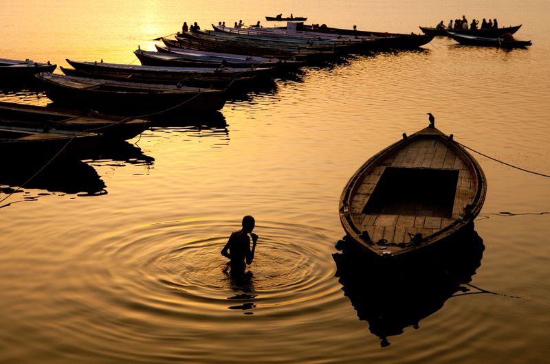 Hindu Pilgrim offers prayers in the River Ganges in Varanasi, India