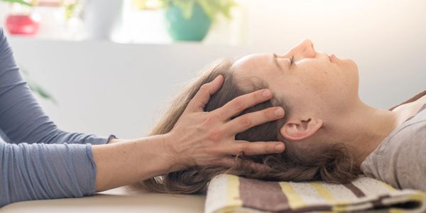 A woman receiving a head massage.