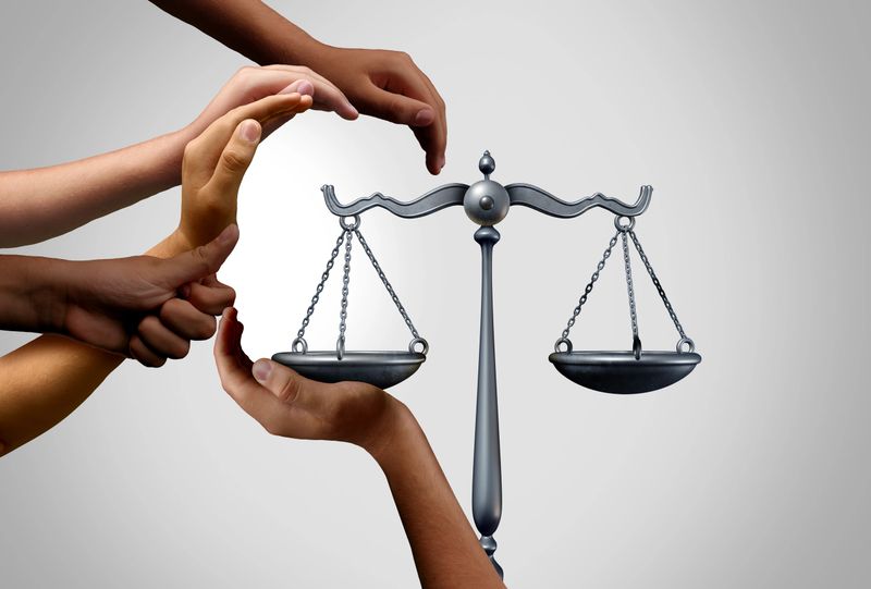 Social justice and diversity equality law in society as diverse people holding the balance in a legal scale as a population legislation or pro bono and class action suit with 3D illustration elements.