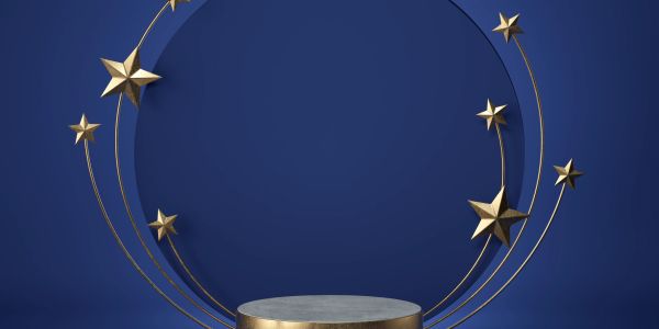 Elegant gold stars on curved wires framing a round pedestal against a deep blue background.