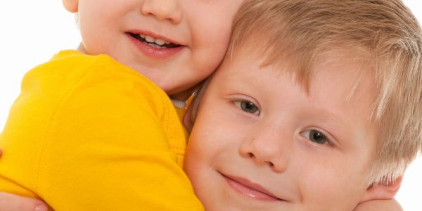 Two children sharing a warm hug.