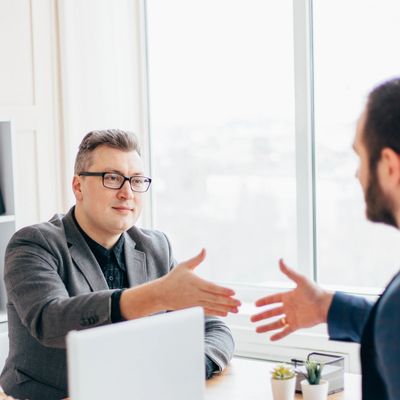 Two businessmen shaking hands in an office.