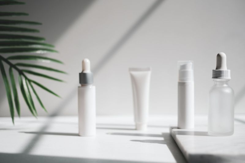 cosmetic skincare packaging . beauty product mock up on luxury white marble with natural light and shadow.