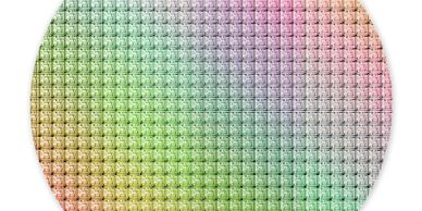 Colorful silicon wafer with microchip patterns in a circular shape.