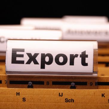 File folder labeled 'Export' among other folders in a filing system.