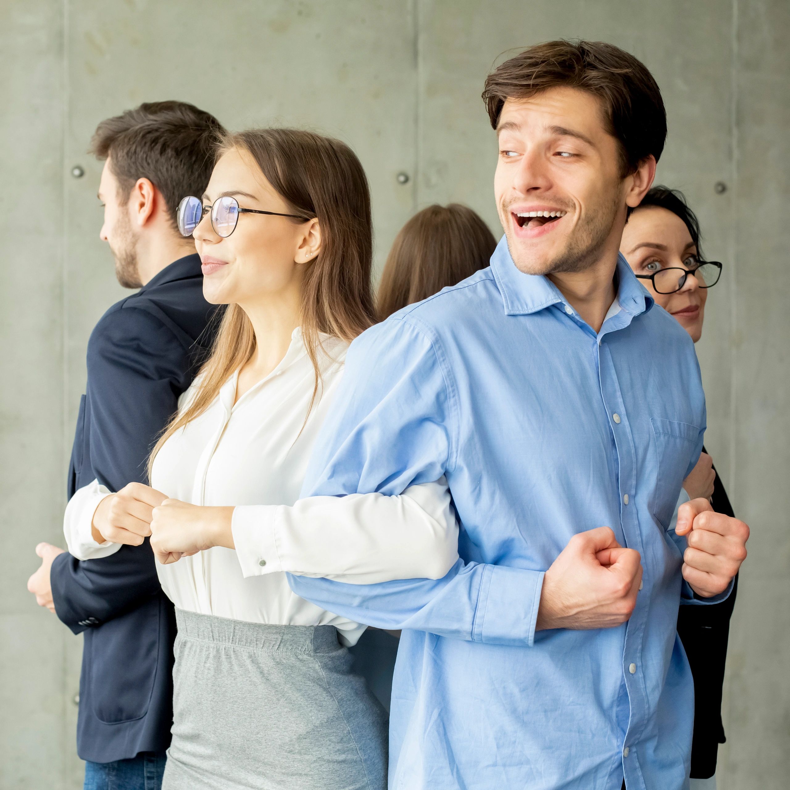 Office colleagues holding each other in a circle