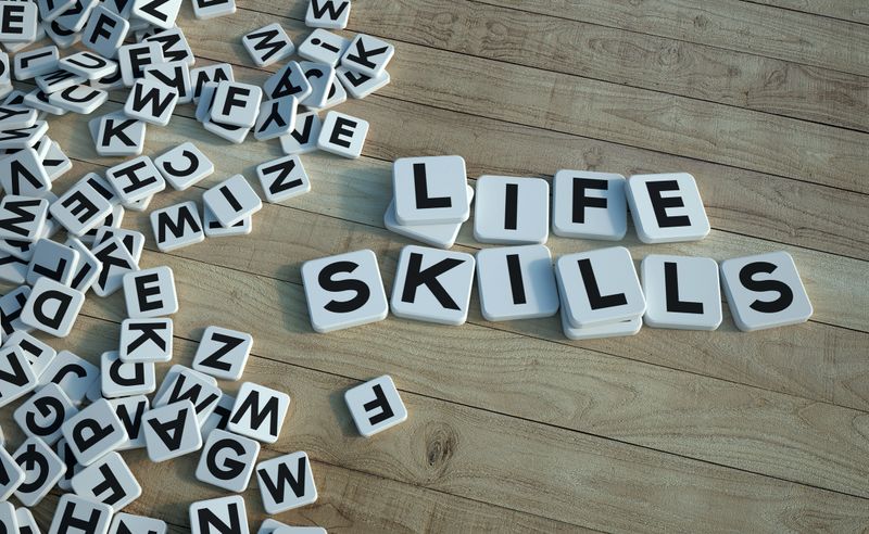 3D rendering of the words life skills written on letter tiles against a wooden background