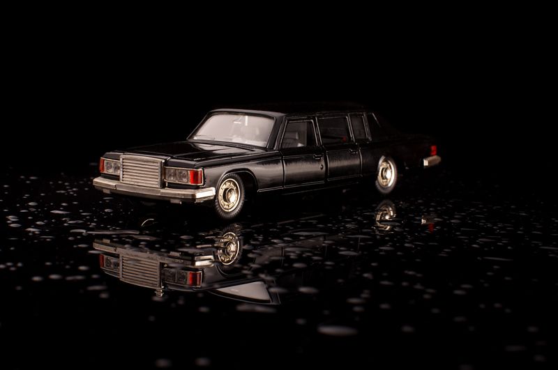 Luxury black soviet car die cast model on the black reflective surface